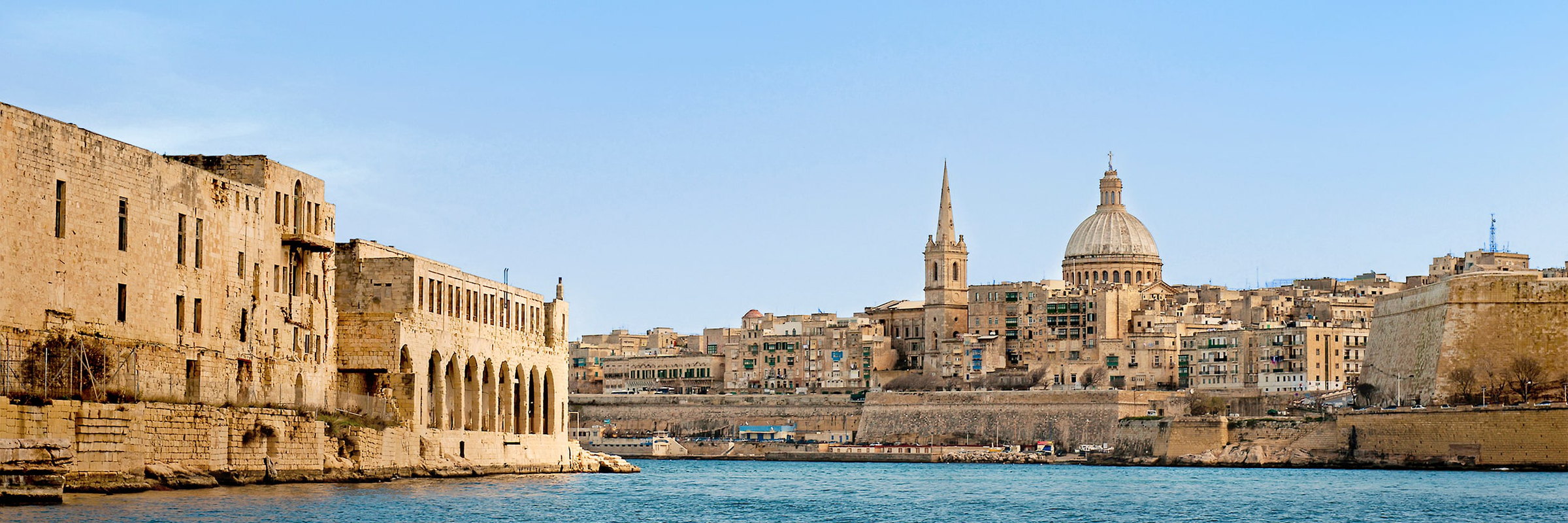 Valletta's Grand Harbour skyline, dome and spire above the waterfront