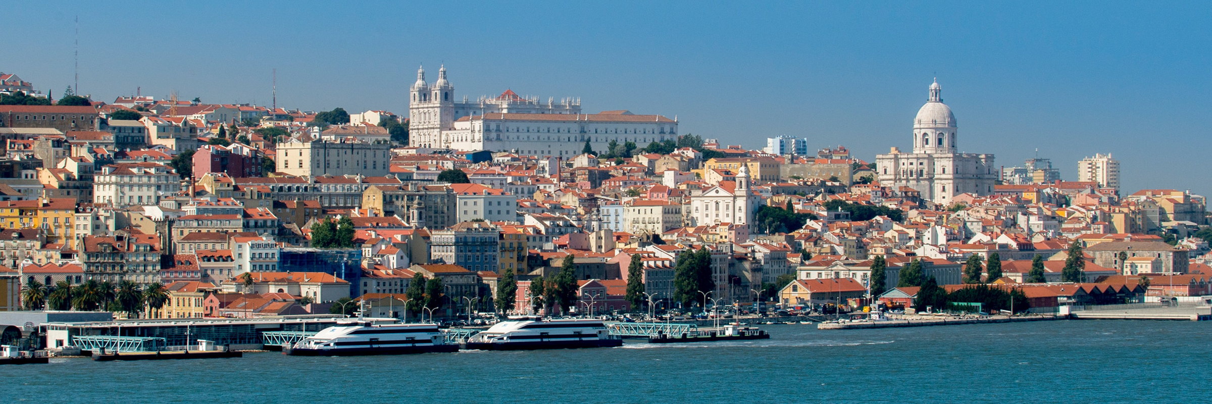 Lisbon's waterfront and ferries seen across the river