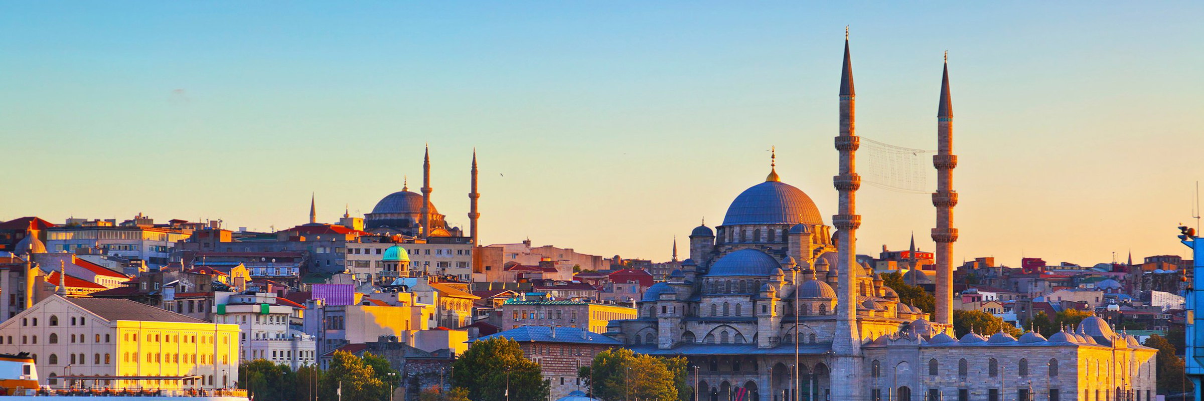 Domes and minarets above the rooftops of Istanbul at golden hour